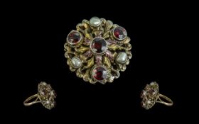 An Antique Austro Hungarian Style Ring set with baroque pearls and garnets, some enamelling, ring
