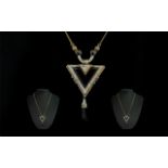 In The Style of The Art Deco Period - Silver Drop Pendant and Necklace,