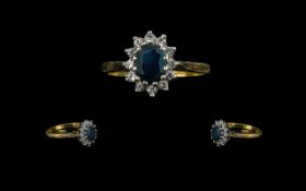 18ct Sapphire and Diamond Cluster Ring with central sapphire surrounded by 12 round cut diamonds.