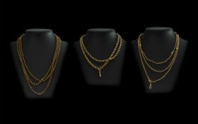 Three Rolled Gold Chains, including two fob chains, and a long chain.