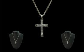 18ct White Gold Diamond Set Cross Attached to a 9ct Gold Chain.