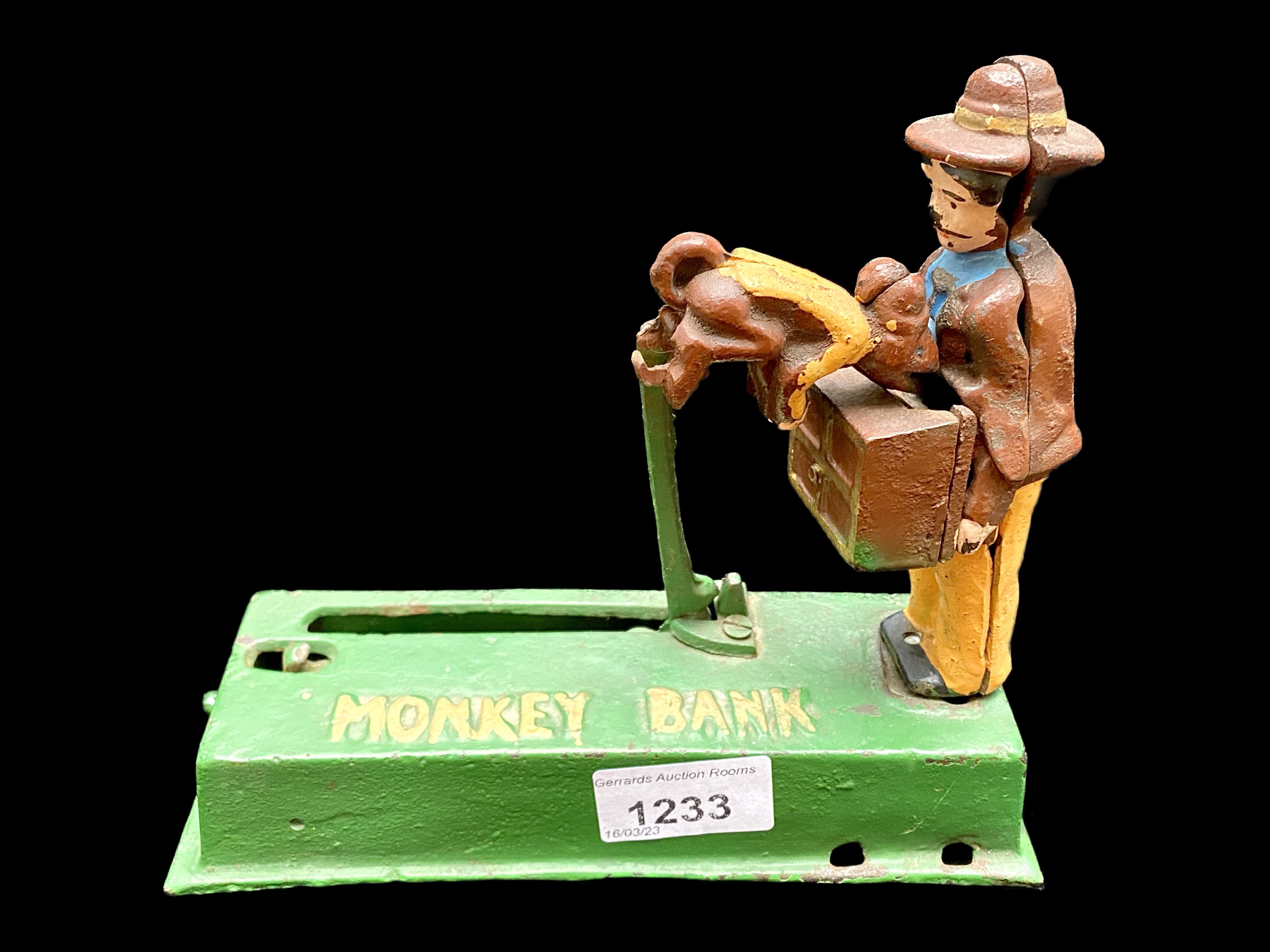 Metal Monkey Money Bank, reproduction bank with a monkey feeding a box held by a man.