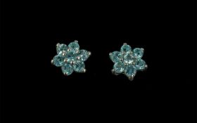 Russian Apatite Star Stud Earrings, each having seven round cuts of the aqua blue apatite,