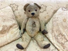 Early 20th Century Teddy Bear. Jointed straw filled bear, padded paws, glass eyes. Approx.