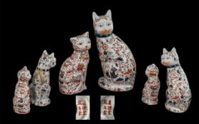 Two Oriental Porcelain Cats, decorated with dragons and flowers, both marked to base.