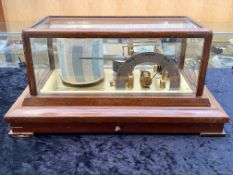 A Barograph by Negretti and Zambra 'Regent' within glazed case above a chart drawer,