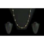 18ct Gold Attractive Necklace set with cultured pearl spacers, marked 750 - 18ct; weight 15.7g,