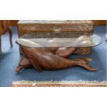 Carved Wood Dolphin Table, depicting two dolphins cascading through the ocean. Glass topped.