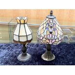 Two Tiffany Style Lamps, one in cream with coloured design in blue and peach,