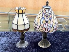 Two Tiffany Style Lamps, one in cream with coloured design in blue and peach,