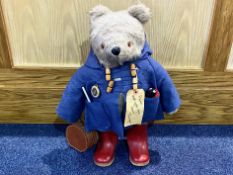 Original Paddington Bear Teddy, dressed in duffle coat and redwellingtons with a bag,