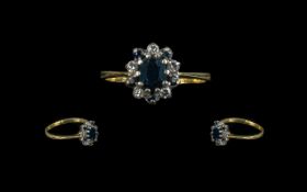 18ct Sapphire and Diamond Cluster Ring central sapphire surrounded by alternating sapphire and