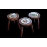 Three Modern Milking Stools, inlaid with porcelain tiles, on turned supports. 11.5" tall.