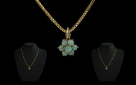9ct Gold Opal Pendant, set in a flowerhead, suspended on a 9ct gold box chain. Approx 16".