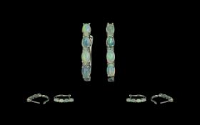 Opal J-Hoop Earrings, four oval cut opals, displaying a variety of colours, set down the front of