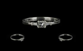 18ct Gold Princess Cut Single Stone Diamond Ring with tapered Baguette cut shoulders. Ring size P.