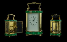 An English Henley Carriage Clock, with a Malacite trim and brass case.