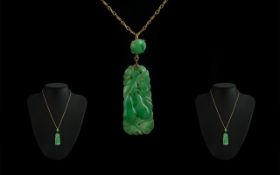 Mid 20th Century 9ct Gold Mounted Jade Pendant attached to a 9ct gold chain,