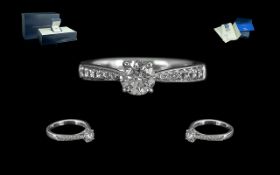 Ladies Superior Quality Platinum Diamond Set Dress Ring. The Central Round Brilliant Cut Diamond