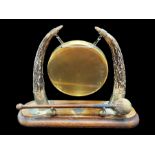 Edwardian Horned Gong, on a wooden plinth, two horns with brass ends with a gong between,