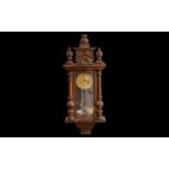 Vienna Wall Clock, working order, decorative columns, and carved finial.