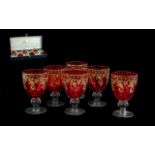 Six Italian Cranberry Wine Glasses, made by Alpha & Omega of Italy, decorated with gilt highlights.