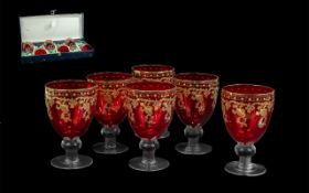 Six Italian Cranberry Wine Glasses, made by Alpha & Omega of Italy, decorated with gilt highlights.