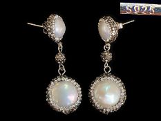 Pair of Pearl Drop Earrings, surrounded by crystal stones.