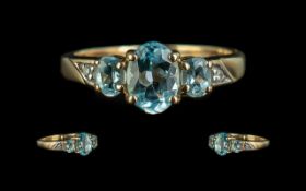 Ladies 9ct Gold Attractive 3 Stone Aquamarine Set Ring with Diamond Set Shoulders.