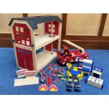 Child's Wooden Fire Station, measures 22" high x 23" wide, with a box of wooden fire equipment,