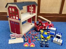 Child's Wooden Fire Station, measures 22" high x 23" wide, with a box of wooden fire equipment,