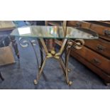 Glass Topped Conservatory Table, raised on four ornate metal legs in brushed bronze.