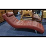 Large Dark Red Leatherette Modern Chaise Longues, fitted headrest, steel legs.