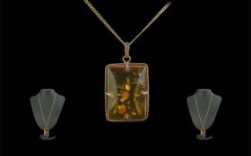 A Ladies 14ct Gold Attractive Amber Set Pendant of Rectangular Form with Attached 9ct Gold Long