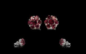 Rhodolite Garnet Flower Form Stud Earrings, each earring comprising seven round cut garnets,