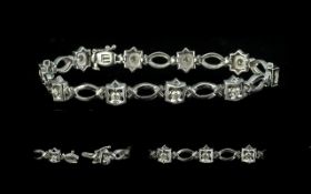 18ct White Gold Diamond Bracelet, set with ten diamonds with oval white gold spacers between, .