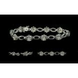 18ct White Gold Diamond Bracelet, set with ten diamonds with oval white gold spacers between, .