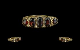 18ct Gold Garnet & Diamond Ring, five graduating garnets with diamond spacers,