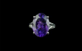 Amethyst Solitaire Ring, an 11ct oval cut amethyst of a rich, noble purple shade, set in an open