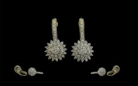 Pair of Diamond Cluster Earrings, diamond sunburst drop set in 9ct gold.