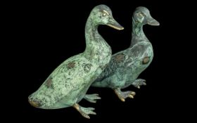 Pair of Bronze Ducks, 8'' tall, finished with a green patina. Attractive items for home or garden.