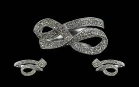 9ct White Gold Diamond Set Bow Ring, Weight 3.45 grams. Bow set with small round cut diamonds.