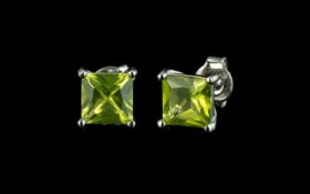 Peridot Princess Cut Stud Earrings, a pair of peridot solitaires, of brilliant colour and clarity,