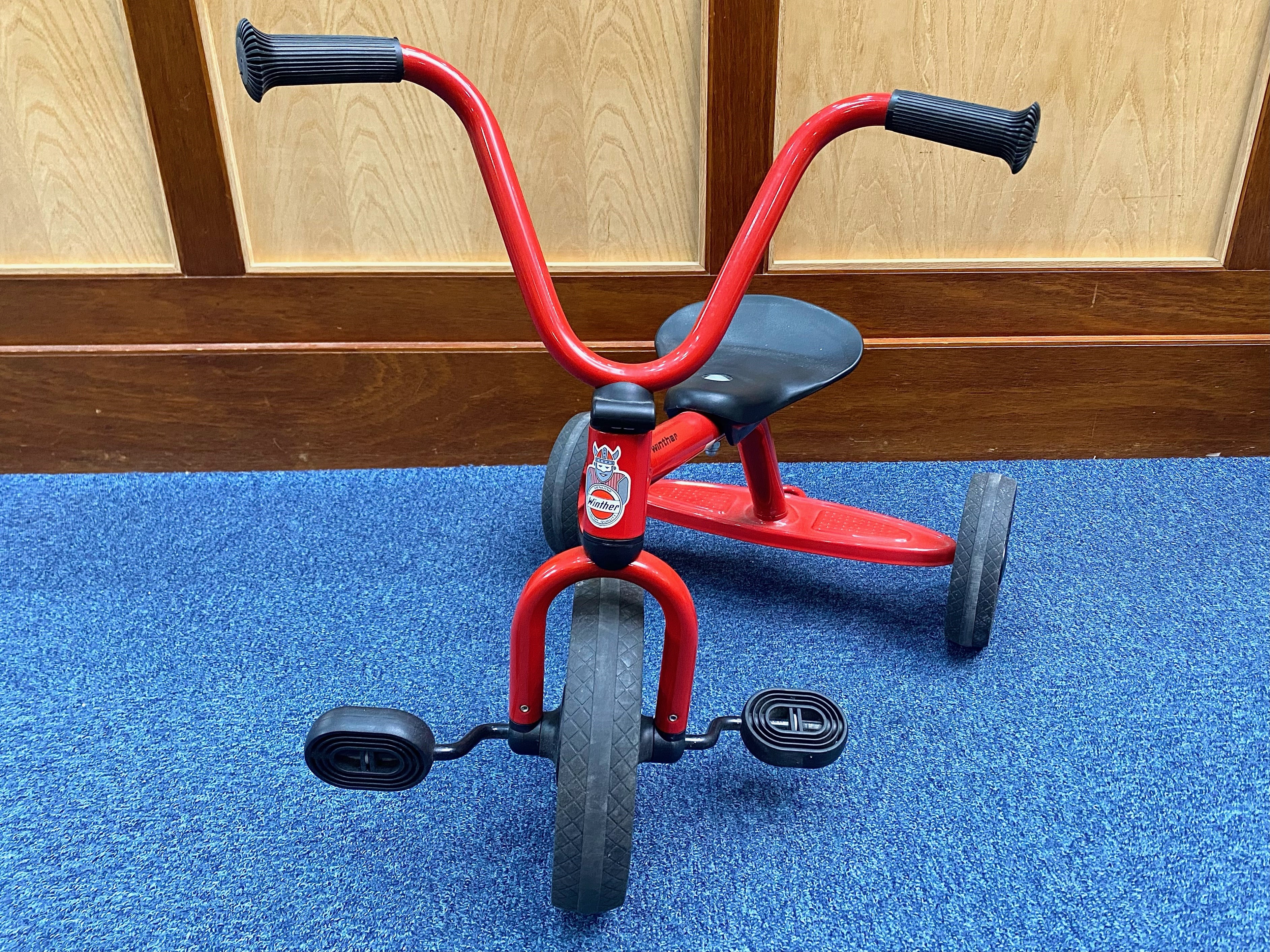 Child's Winther Tricycle, made in Denmark, red rust-proof finish with black saddle and three wheels.