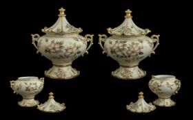 Pair of Hand Painted Lidded Pots, decorated with flowers and birds, with gilt trim. Raised on