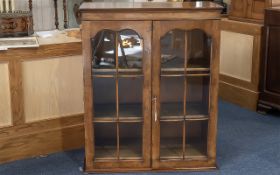Glazed Fronted Bookcase, three shelves, two glazed doors. Measures 31'' wide x 16'' diameter x