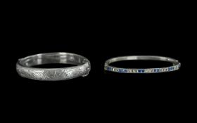 A Silver Hinged Embossed Bangle, with safety chain (needs reattaching), together with a slim