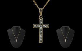 9ct Gold Diamond Set Cross with attached 9ct gold chain, both marked 9.375, the cross set with