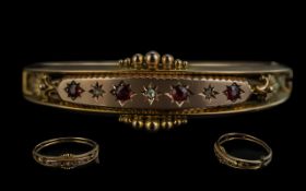 Edwardian Period 1901 - 1910 Attractive 9ct Gold Hinged Bangle set with rubies and diamonds, fully