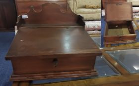 A Victorian Mahogany Clerks Writing Slope with shaped gallery top with a hinged slope. Width 17